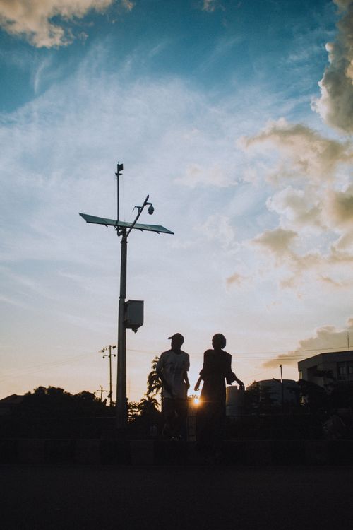 Free Silhouette of two people against a stunning sunset sky in Kaduna, Nigeria. Stock Photo