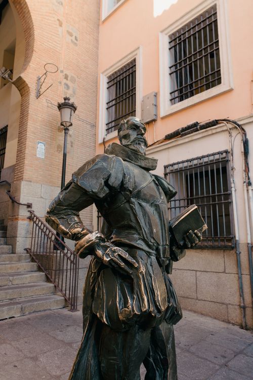 Free Bronze sculpture of Miguel de Cervantes, located in historic Toledo, Spain. Iconic literary tribute. Stock Photo