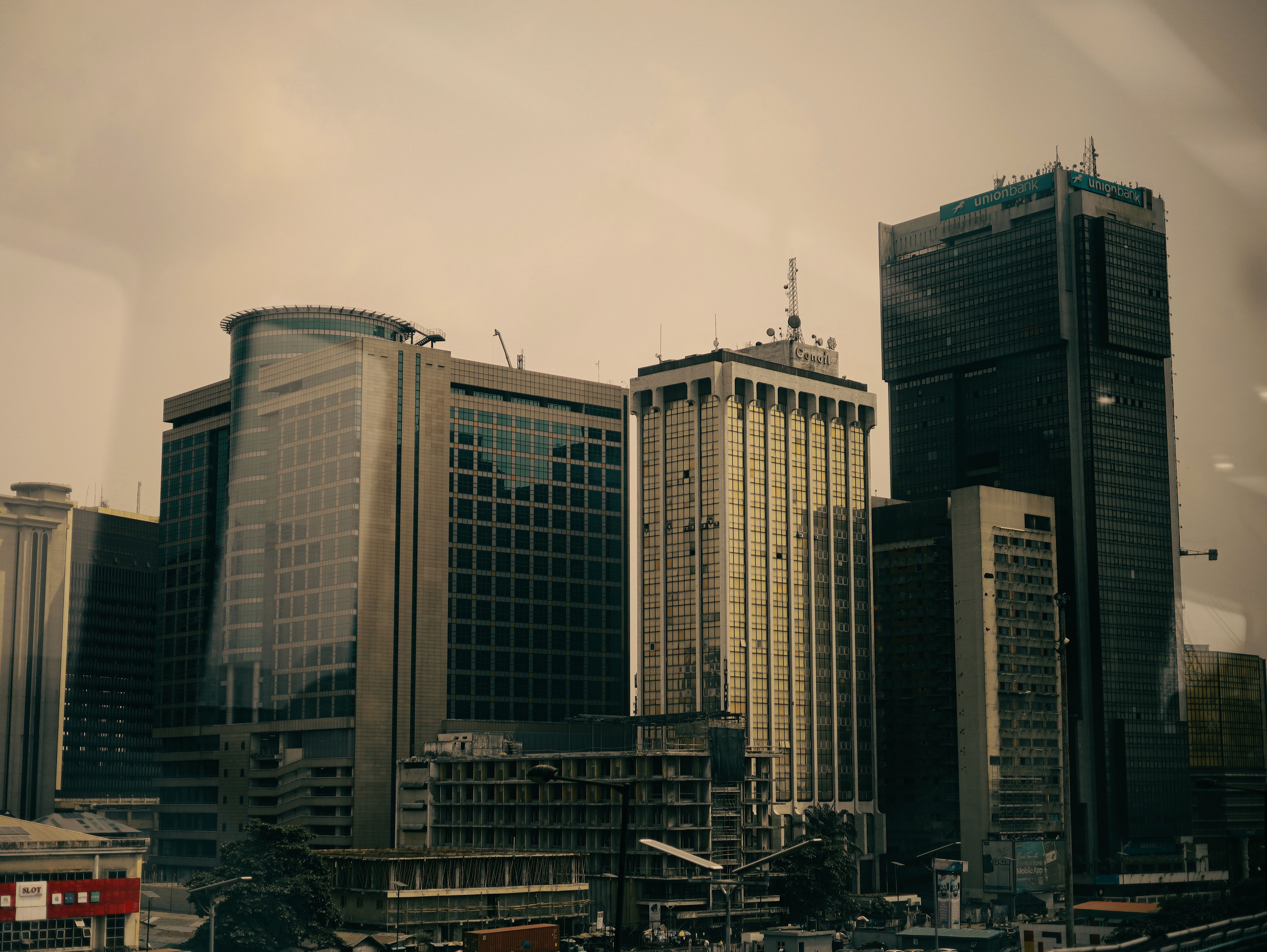 Dramatic view of modern skyscrapers under a dusky sky, showcasing urban architecture.