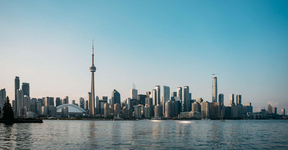 Busy downtown Toronto street reflecting immigration and Canada's economy