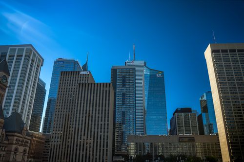 Free Toronto cityscape showcasing modern skyscrapers against a clear summer sky, highlighting urban architecture. Stock Photo