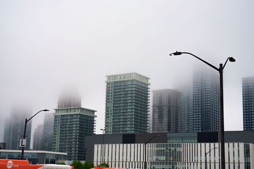 Free Mist envelops skyscrapers in Mississauga, Ontario, creating a mysterious urban scene. Stock Photo