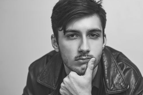 Free Black and white portrait of a thoughtful man in a leather jacket, reflecting serious mood. Stock Photo