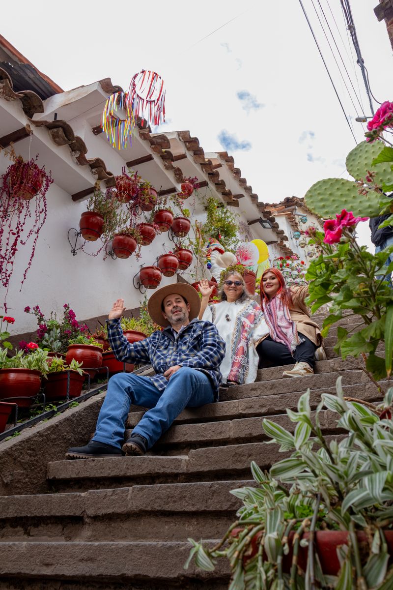 Group enjoying the flower-decorated San Blas steps in Cusco
