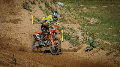 Free A motocross rider takes on a challenging dirt track in an outdoor race. Stock Photo