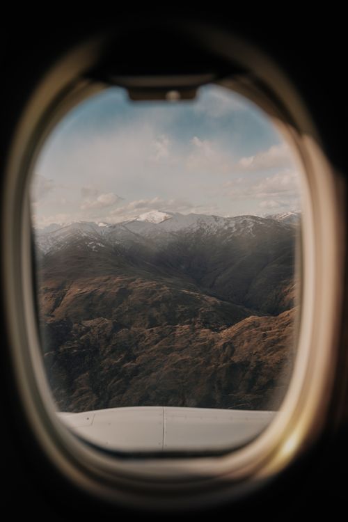 Free Captivating view of New Zealand mountains through an airplane window. Experience travel and adventure. Stock Photo