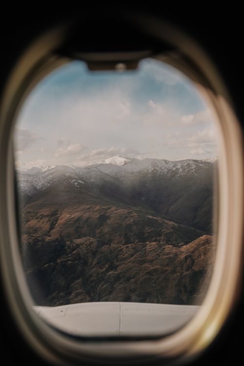 Free Scenic aerial view of New Zealand's mountains through an airplane window. Stock Photo
