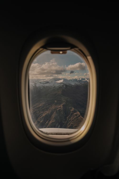 Free A breathtaking view of New Zealand's mountains through an airplane window. Stock Photo