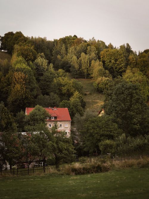 Free Picturesque view of a countryside house surrounded by lush greenery in Lower Silesian Voivodeship, Poland. Stock Photo