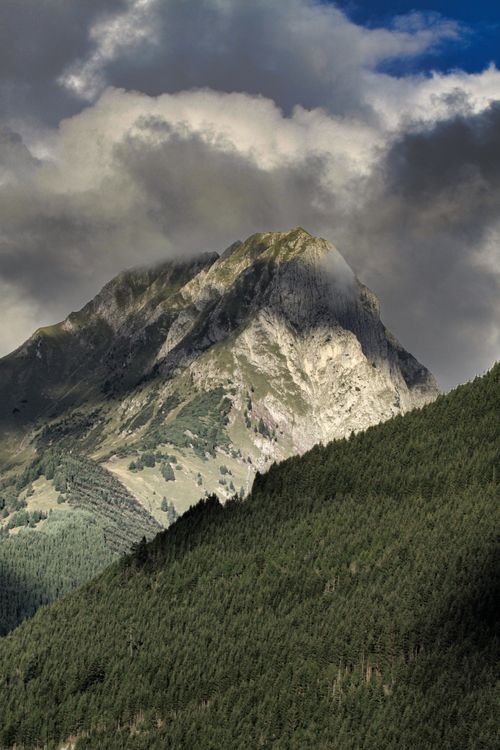 Free Dramatic view of a mountain peak under cloudy skies in Lech, Vorarlberg, Austria. Stock Photo