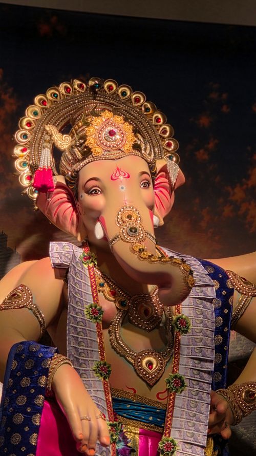 Free A vibrant and detailed statue of Lord Ganesh adorned with colorful jewelry and attire, embodying cultural richness. Stock Photo