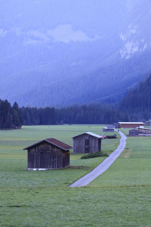 Free Peaceful rural scene with wooden barns and lush green meadows in Lech, Vorarlberg, Austria. Stock Photo