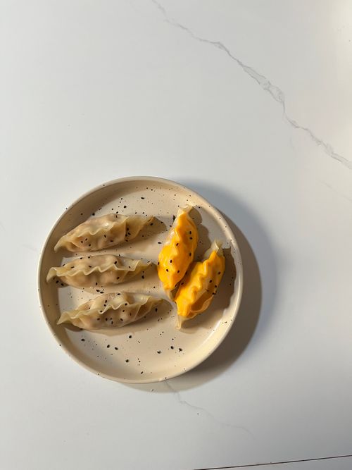 Free A plate of steamed dumplings with chopsticks, showcasing mixed Asian cuisine. Stock Photo