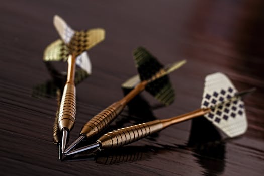 Brass Gold Darts on Brown Table