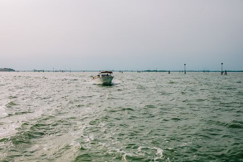 Free A small motorboat gliding on open waters under a clear sky, evoking tranquility. Stock Photo