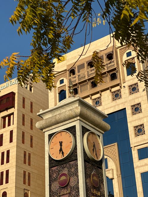 Free Tall clock tower amidst traditional Saudi architecture and clear blue sky in Saudi Arabia. Stock Photo