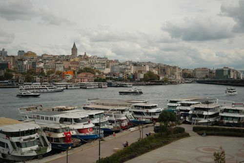 Free Scenic view of Istanbul's harbor with Galata Tower and boats lining the waterfront. Stock Photo
