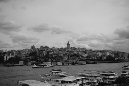 Free Monochrome photo capturing the Galata Tower and Istanbul city's landscape across the water. Stock Photo