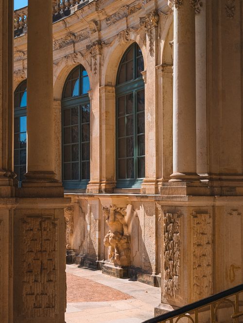 Free Sunlit classical façade of Zwinger Palace in Dresden showcasing intricate sculptures and ornate columns. Stock Photo