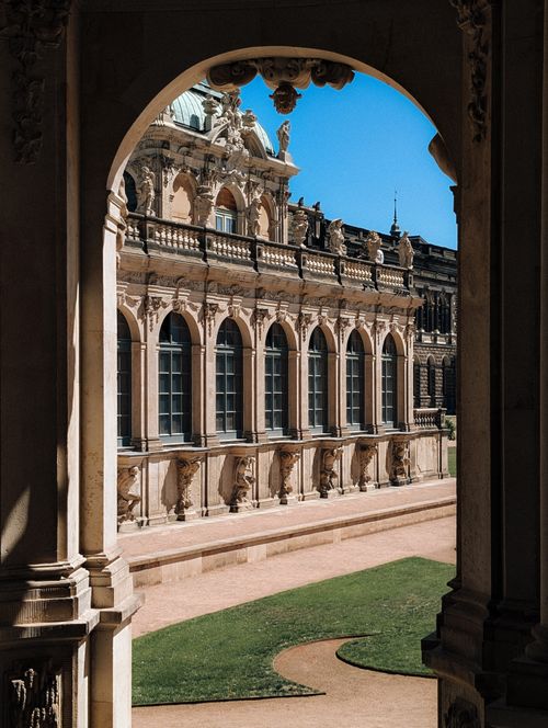Free Beautiful view of Dresden's Zwinger Palace showcasing Baroque architecture under a clear blue sky. Stock Photo