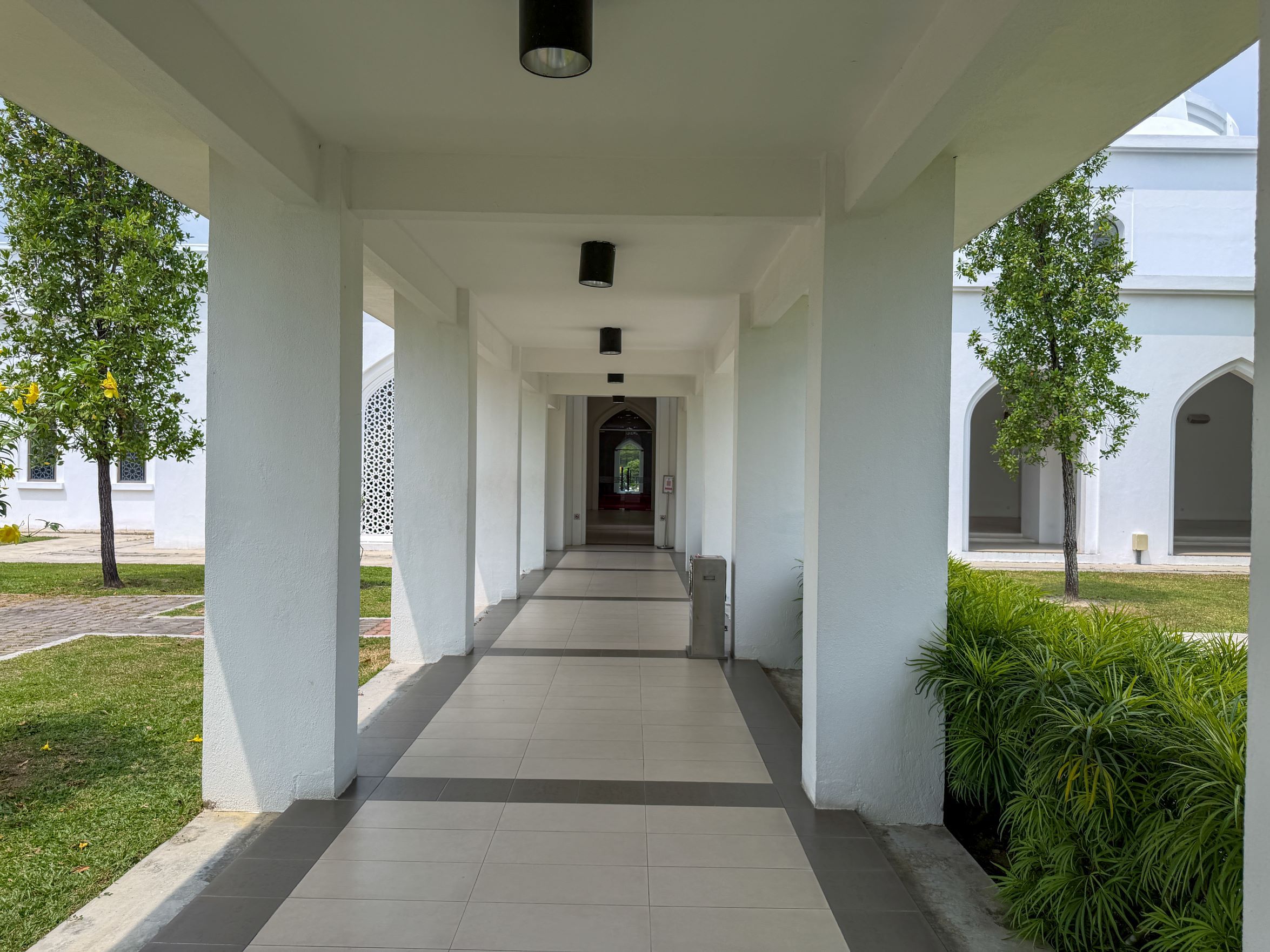 A peaceful walkway with white pillars and arches in Seremban, Negeri Sembilan, Malaysia.