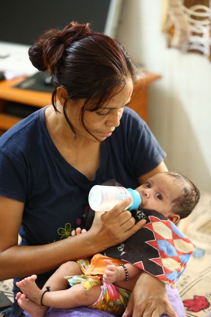 newborn baby feeding sunlight window