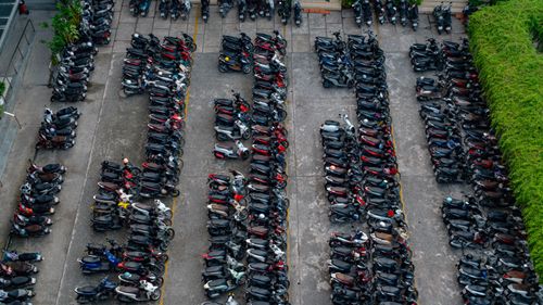 Free Aerial shot of neatly organized scooters parked in a lot, showcasing urban transportation. Stock Photo