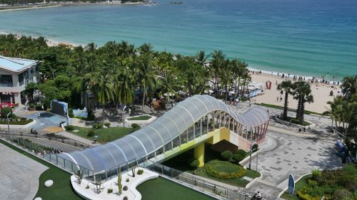 Free Aerial view of a beautiful beach and walkway at Sanya, Hainan, China with clear blue waters. Stock Photo