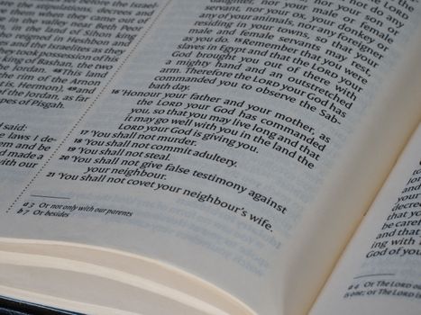 Detailed view of a Bible page showing the Ten Commandments text, ideal for religious and educational themes.