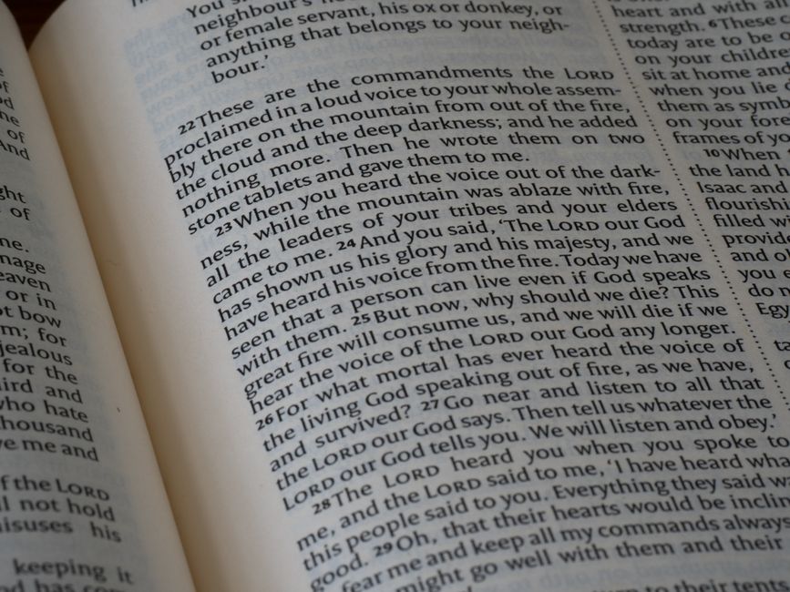 Detailed close-up of a Bible page showing text from the book of Deuteronomy.