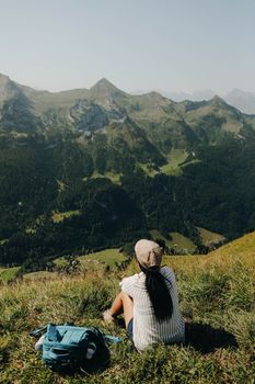 Woman enjoying a breathtaking mountain landscape, ideal for adventure and travel themes.