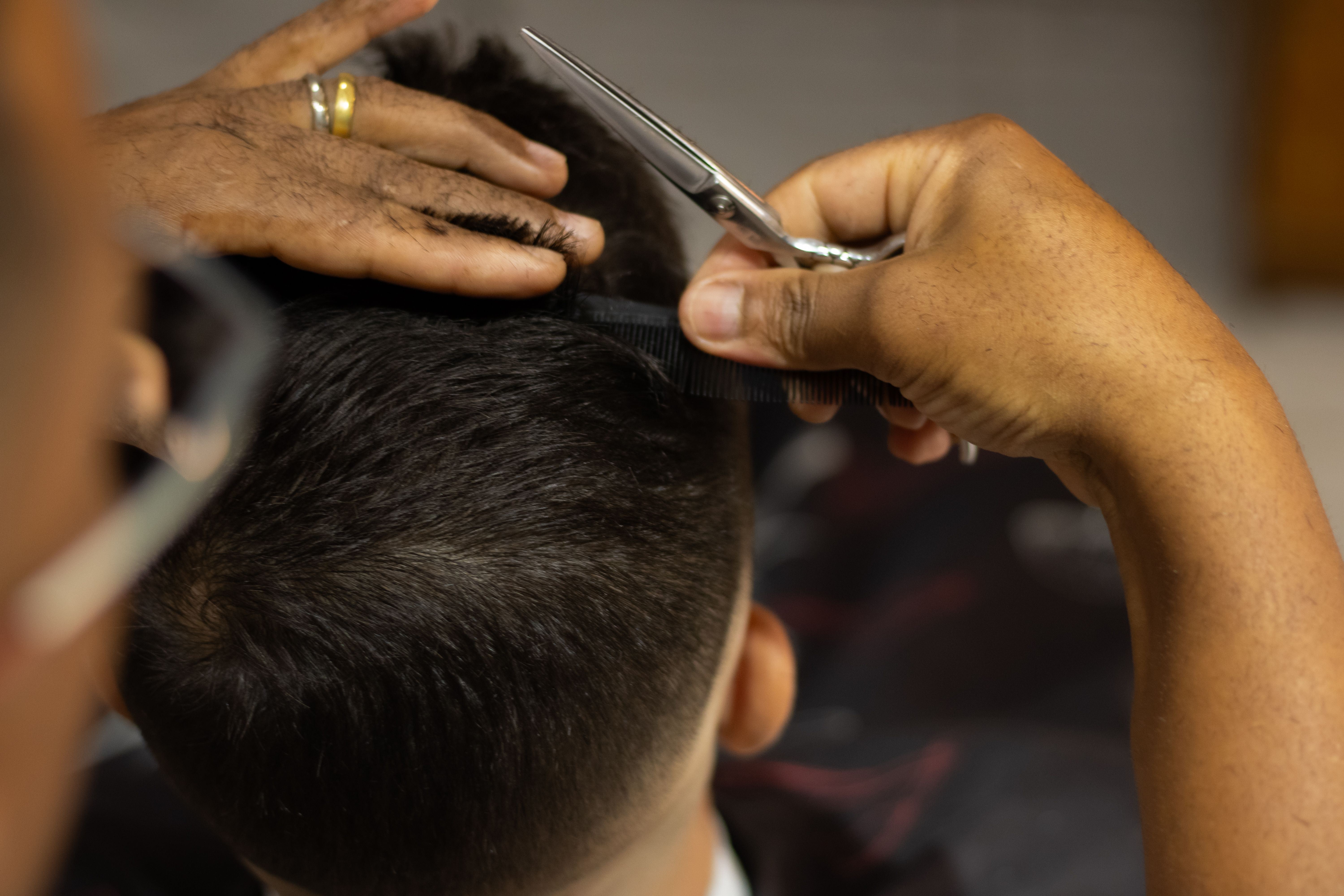 Senior barber with professional scissors and comb