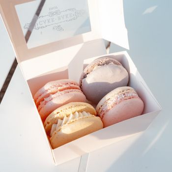 Delicious variety of colorful French macarons in an elegant box, ideal for dessert lovers.