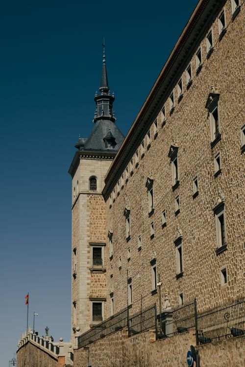 Free The majestic Alcázar of Toledo captured under a clear blue sky. Iconic Spanish architecture. Stock Photo
