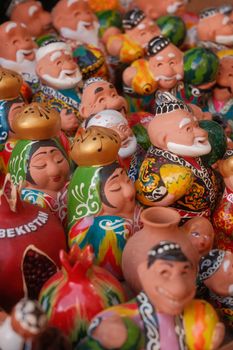 Vibrant collection of traditional Uzbek ceramic figurines and souvenirs on display.
