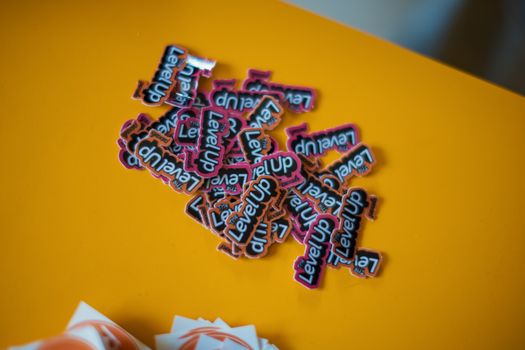 A vibrant stack of 'Level Up' stickers on a bright orange background, perfect for gaming or motivational themes.