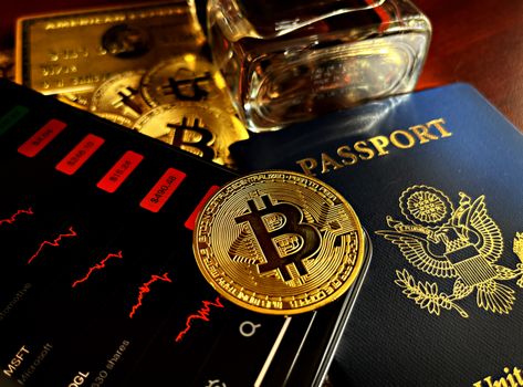 A golden Bitcoin, gold bars, and a passport representing financial freedom and investment.