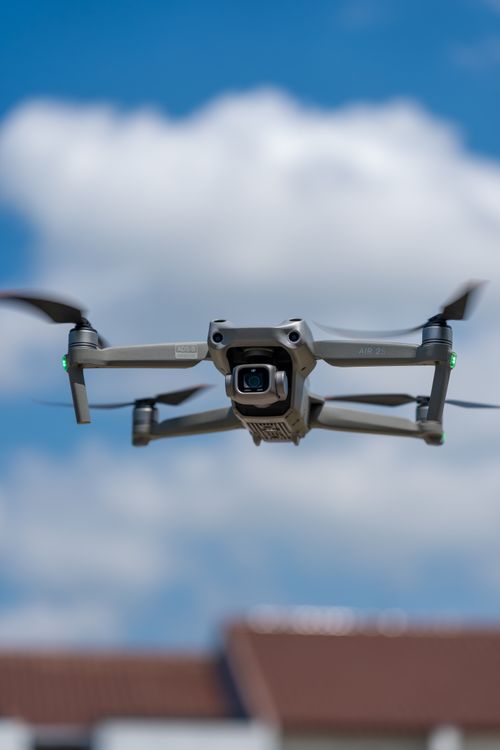 Free A sleek, modern drone captured mid-flight against a crisp, clear sky, demonstrating advanced technology. Stock Photo