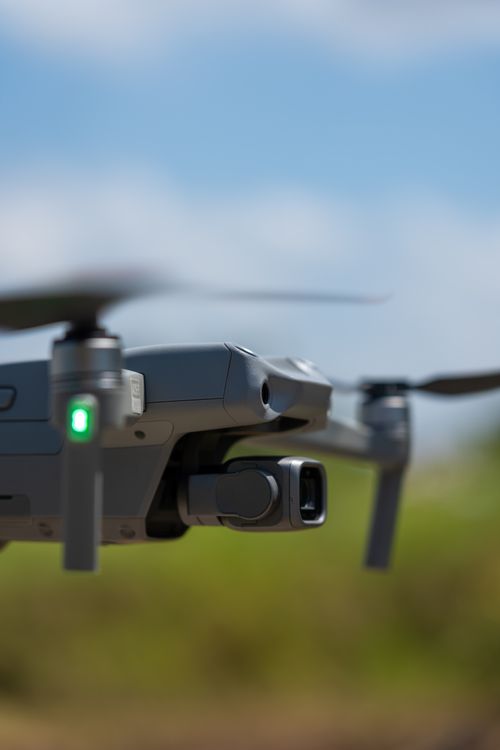 Free Macro shot of a flying drone with blurred natural background on a sunny day. Stock Photo