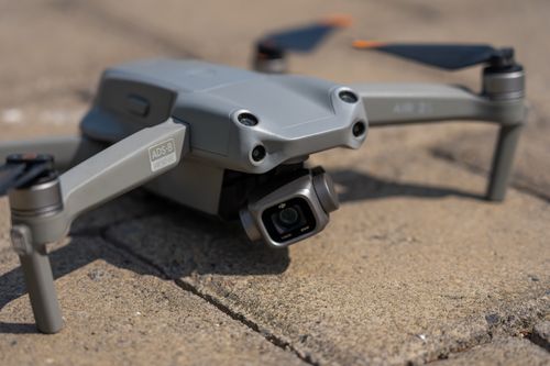 Free Grey drone with camera on concrete, featuring ADS-B technology. Stock Photo