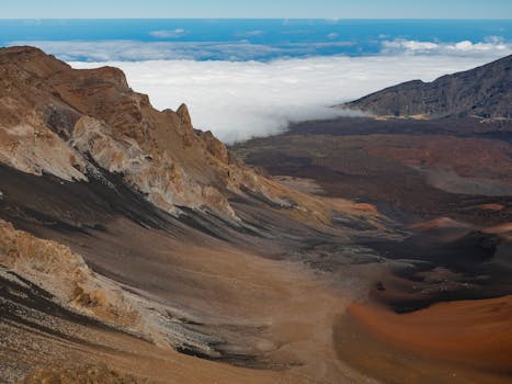 Breathtaking view of Haleakala Crater with clouds in the distance on Maui, Hawaii.