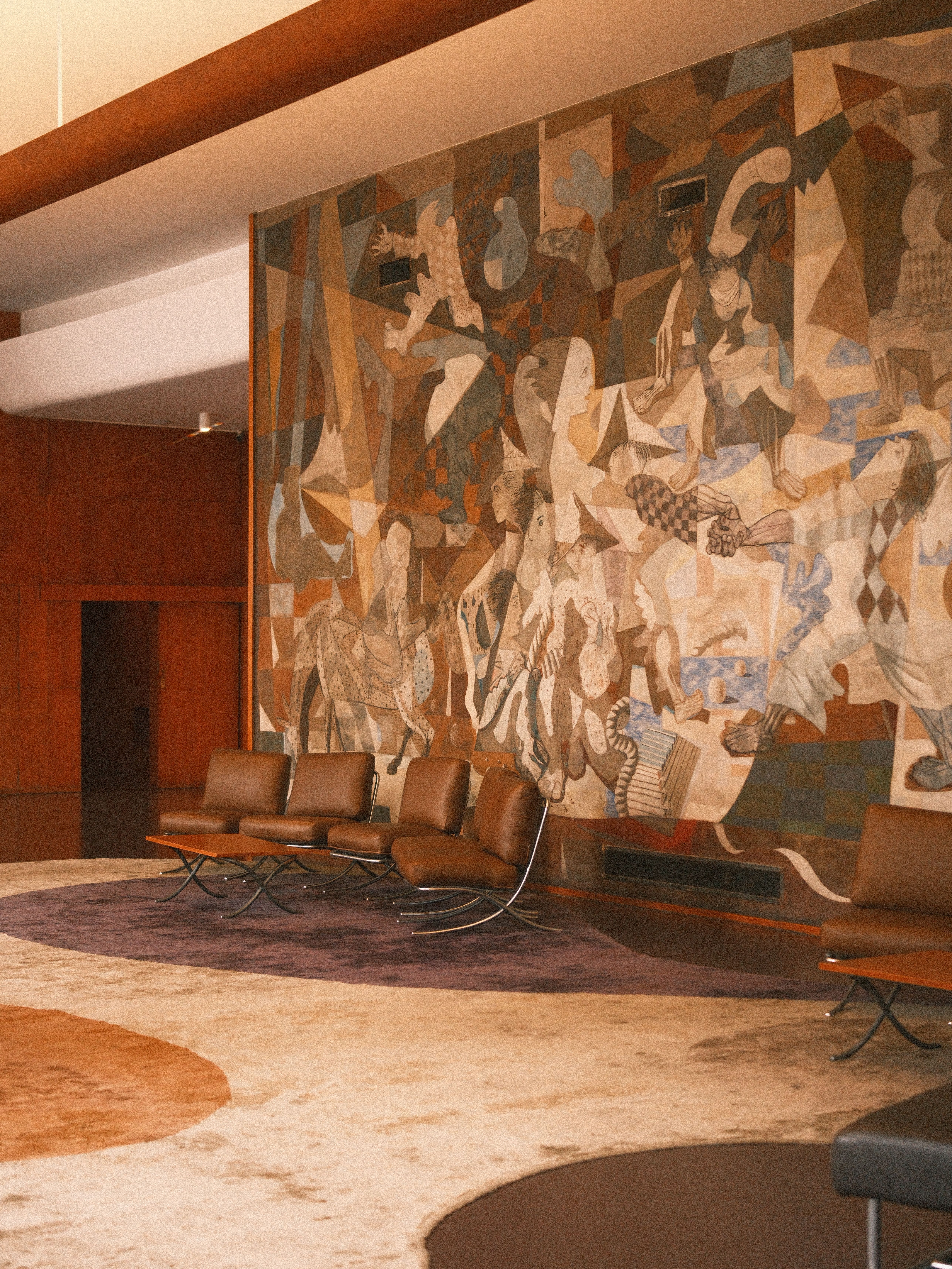 Elegant lounge in Rio de Janeiro with a stunning modernist art mural on the wall.