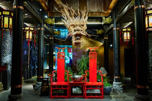 Free Stunning oriental-style interior with a central dragon sculpture and red traditional chairs. Stock Photo