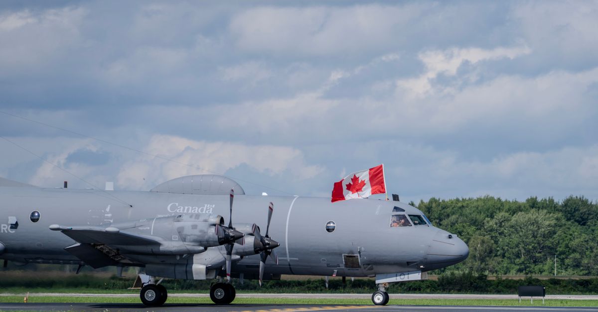 Military aircraft with a Canadian flag displayed, captured on a clear day at an airshow.