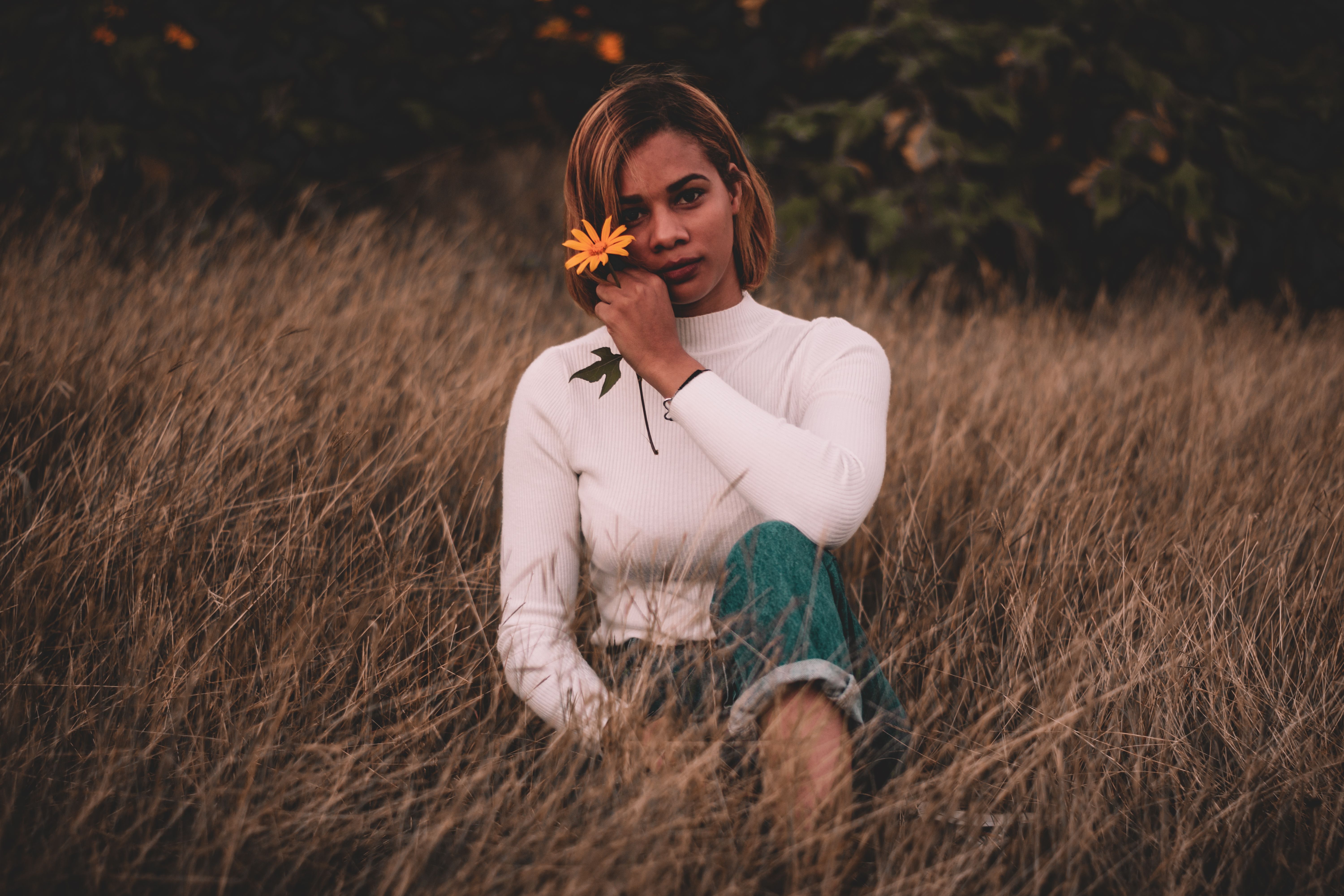 Woman In White Long Sleeve Shirt Sitting On Brown Grass Field · Free ...