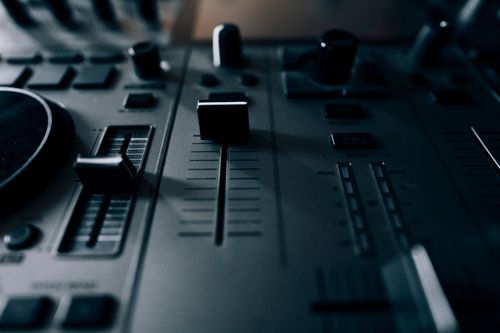 Free A detailed look at a DJ mixing console with knobs and sliders for music production. Stock Photo
