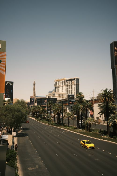 Free A bright sunny view of Las Vegas Strip with the Eiffel Tower replica and palm-lined roads. Stock Photo