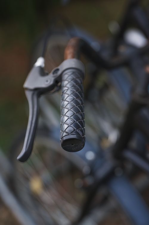 Free Detailed view of a bicycle handle grip and brake lever captured outdoors. Stock Photo
