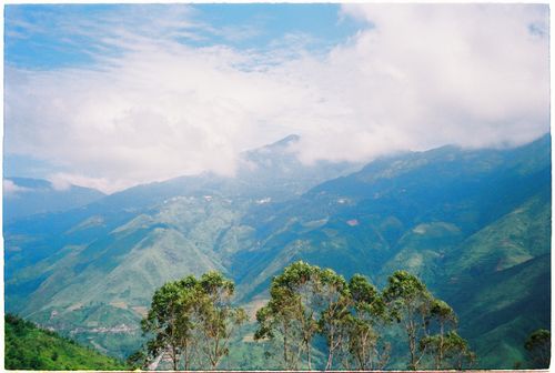 Free Breathtaking view of lush green mountains beneath a cloudy sky. Stock Photo
