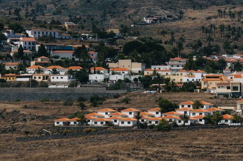Free Picturesque view of Alajeró village with vibrant rooftops in a volcanic landscape. Stock Photo